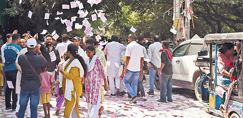 Scenes from Delhi University on Friday — a lot of flyers were seen scattered on the road; long queues of voters were noticed at some places outside the  polling booths