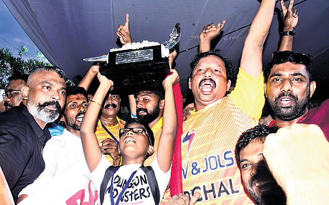 Members of Pallathuruthy Boat Club, which won the 70th Nehru Trophy Boat Race rowing Karichal Chundan, with the trophy on Saturday 