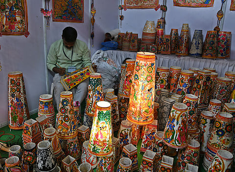 An Artist is seen colouring the bed lamp units  at SARAS Exhibition in peoples plaza in Hyderabad.