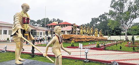 Life-size sculptures of Mahatma Gandhi with a boy and the Dandi March