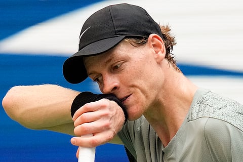Jannik Sinner, of Italy, wipes sweat from his face between serves to Mackenzie McDonald, of the United States, during the first round of the U.S. Open tennis championships, Tuesday, Aug. 27, 2024, in New York. 