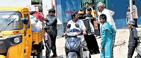 Families shift with household articles to new 2BHK houses on Saturday 