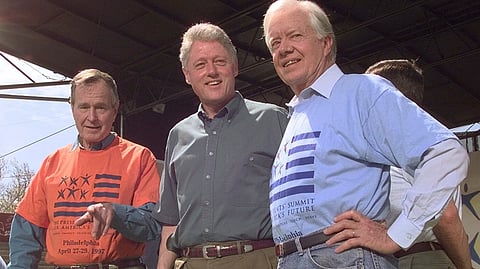Former Presidents George Bush, left, and Jimmy Carter, right, stand with President Clinton during a kick-off rally for the President's volunteer summit at Marcus Foster Stadium in Philadelphia, PA., April 27, 1997. 