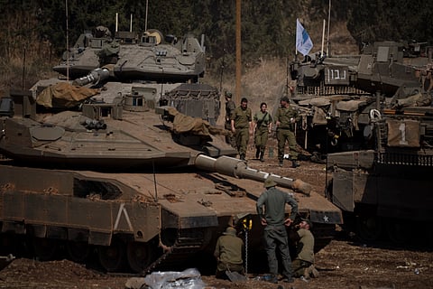 Israeli soldiers work on tanks and armoured personnel carriers (APC) in northern Israel, Monday, Sept. 30, 2024. 
