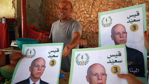Supporters of Tunisian President and candidate for re-election Kais Saied meet with residents of a neighbourhood during a campaign tour, in Ariana, Tunisia, Thursday, Sept. 26, 2024. 
