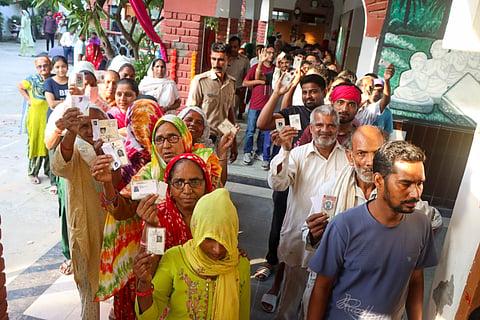 Voters wait in a queue to cast their votes at a polling station during the Haryana Assembly elections, in Rohtak district, Saturday, Oct. 5, 2024.