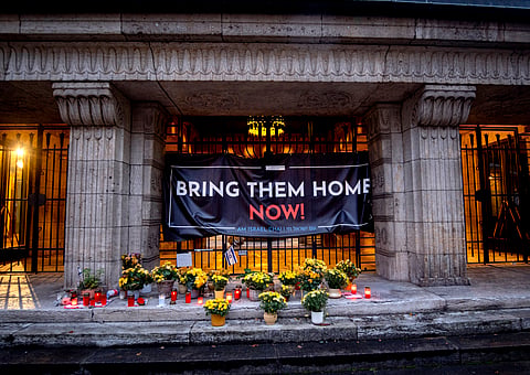 Candles and flowers are laid at the entrance of the synagogue to mark the first anniversary of the Hamas attack on Israel, Frankfurt, Germany.