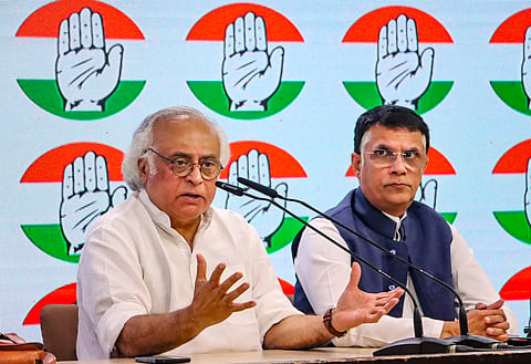 Congress leaders Jairam Ramesh and Pawan Khera address a press conference at AICC headquarters, in New Delhi, Tuesday, Oct. 8, 2024. 