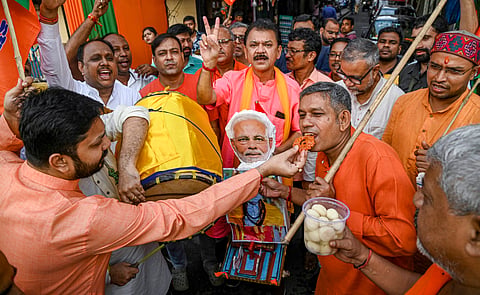 BJP workers celebrate the party's lead during the counting of votes of Haryana Assembly elections, at party office in Kolkata, Tuesday, Oct. 8, 2024. 
