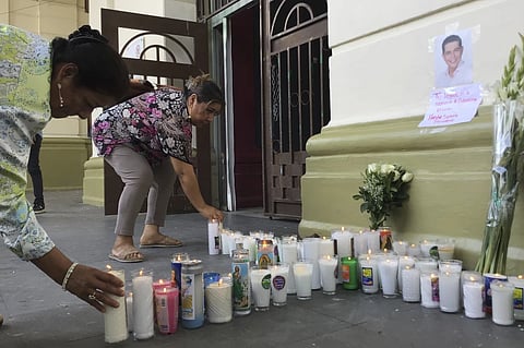Supporters of slain Mayor Alejandro Arcos place candles and flowers at the entrance of the municipal building one week after he took office in Chilpancingo, Mexico, Monday, Oct. 7, 2024. 