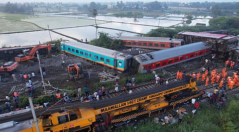 Indian railway workers restoring  the site  by pushing the coaches  of the Mysuru-Darbhanga Bagmati Express train derailed after ramming into the rear of a goods train at the Kavaraipettai Railway Station. 