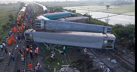Drone shot of Indian railway workers restoring  the site  by pushing the coaches  of the Mysuru-Darbhanga Bagmati Express train at the Kavaraipettai Railway Station.