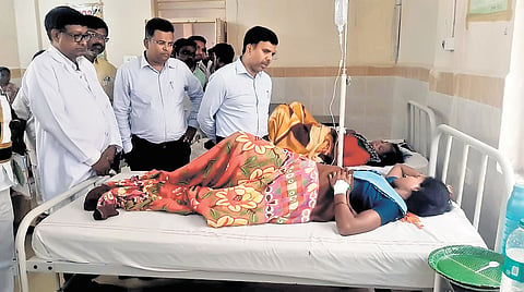 Additional Collector (Local Bodies) Chandrasekhar on Monday interacts with a woman patient  from Sanjeevraopet village who fell ill after drinking contaminated water in Sangareddy district on Saturday