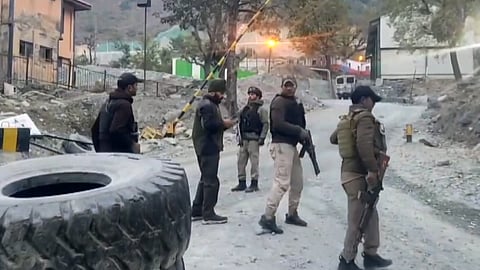 Security personnel cordon off the area after a terrorist attack, in Ganderbal district, Jammu & Kashmir, on Monday