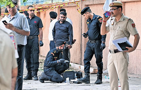 National Security Guard personnel inspect the blast site outside the CRPF school 
at Prashant Vihar in Rohini area of New Delhi on Sunday morning 