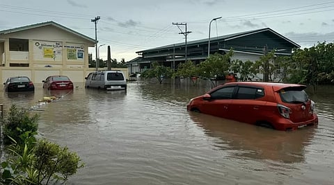 Stranded vehicles are seen near an evacuation centre in floodwaters from heavy rains brought about by Tropical Storm Trami in Naga City, Camarines Sur province, the Philippines, on Oct 23, 2024.