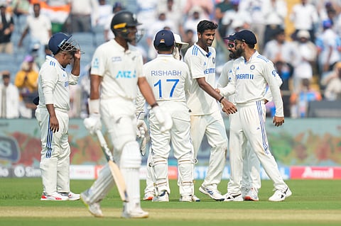 India's Washington Sundar , second from right, celebrates the dismissal of New Zealand's Rachin Ravindra during the day one of the second cricket test match between India and New Zealand at the Maharashtra Cricket Association Stadium , in Pune