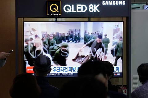 A TV screen shows an image of soldiers believed to be from North Korea stand in line to receive supplies from Russia during a news program at Seoul Railway Station in Seoul, South Korea, Monday, Oct. 21, 2024.