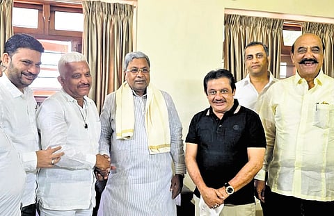 Former MLA Syed Azeempeer Khadri (second from left) greets Chief Minister Siddaramaiah in Bengaluru on Saturday 
