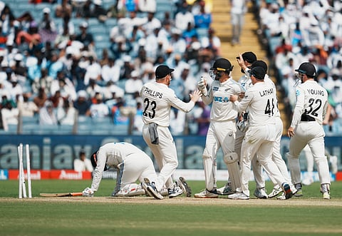 New Zealand players celebrate the wicket of Rishabh Pant in the second Test in Pune.