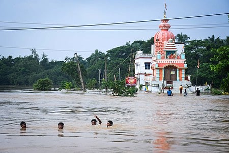 File | Kids swim in the flood water at Baincha Village under Balasore Sadar block after the village marooned due to swelling Budhabalanga river in Balasore district 