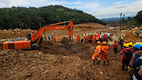 NDRF teams conduct a search operation using an excavator at a landslide-hit area in Wayanad, Kerala, on Aug 9, 2024.
