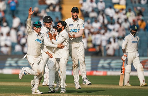  Ajaz Patel (centre) during the second Test in Pune