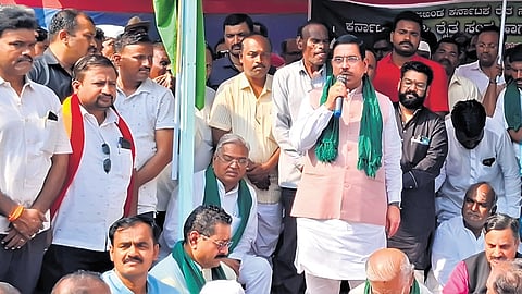 Union Minister for Food and Consumer Affairs Pralhad Joshi addresses agitating 
farmers in Vijayapura on Wednesday 