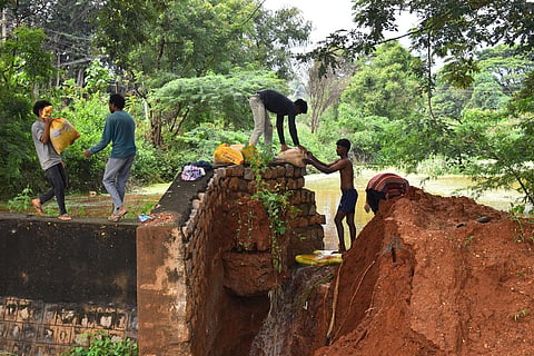The earthen bund of a pond at Somayampalayam village which is a water tributary to the Noyyal River, breached in the wee hours of Friday morning following the heavy rain. 