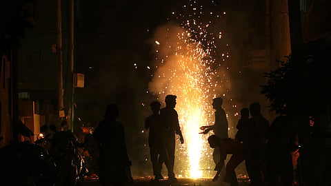 Image of people bursting firecrackers used for representational purpose,