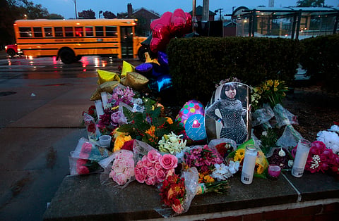 A photo of Alexandria Bell rests at the scene of a growing floral memorial to the victims of a school shooting at Central Visual & Performing Arts High School, Oct. 25, 2022, in St. Louis. 