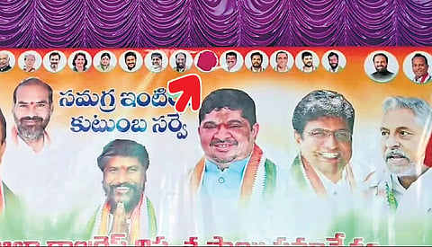 MLA M Sanjay Kumar’s photo is seen covered with a red sticker on a banner put up for a meeting on caste census in Jagtial on Sunday