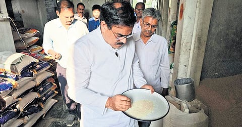 Civil Supplies Minister N Manohar inspecting the quality of rice at a mill 