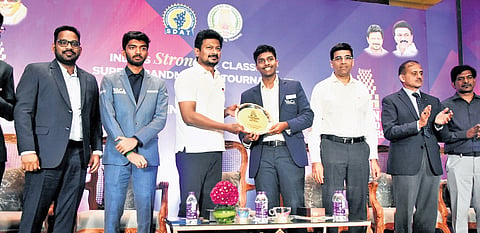 Deputy CM Udhayanidhi Stalin (3rd from left) hands over the trophy to winner Aravindh Chithambaram in Chennai on Monday.