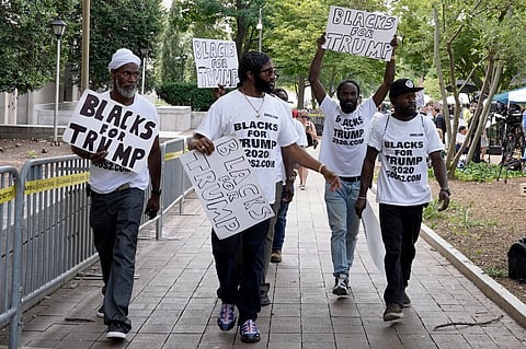 Supporters of former President Donald Trump with signs and t-shirts that read "Blacks for Trump" gather near the E. Barrett Prettyman U.S. Federal Courthouse, Aug. 3, 2023, in Washington. 