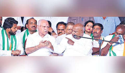 Former prime minister and JDS supremo HD Deve Gowda in conversation with BJP leader and former chief minister BS Yediyurappa during a campaign for NDA candidate Nikhil Kumaraswamy in Channapatna on Monday 