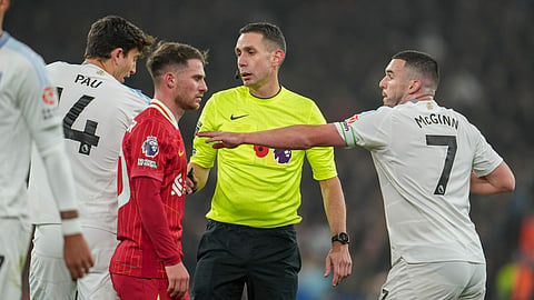 Referee David Coote officiates during the English Premier League soccer match between Liverpool and Aston Villa at the Anfield stadium in Liverpool.