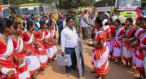 Women from the tribal community give a traditional welcome to a polling official before he leaves for his alloted polling station on the eve of the 1st phase of Jharkhand Assembly elections, in Ranchi, Tuesday, Nov 12, 2024.