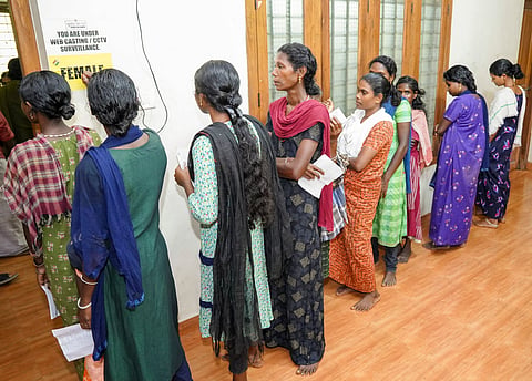 Tribal voters wait to cast their votes for the Wayanad Lok Sabha by-poll, Wednesday, Nov. 13, 2024. 