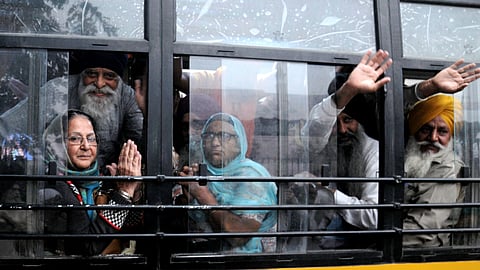 Sikh pilgrims raise religious slogans before departing for Pakistan to participate in celebrations marking the birth anniversary of Guru Nanak Dev, in Amritsar, Thursday, Nov. 14, 2024.