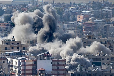 Smoke rises between buildings hit in an Israeli airstrike in Dahiyeh, in the southern suburb of Beirut, Lebanon