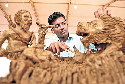 Jishnu, a Class X student with special needs from Kochi, gives final touch to his intricate clay model