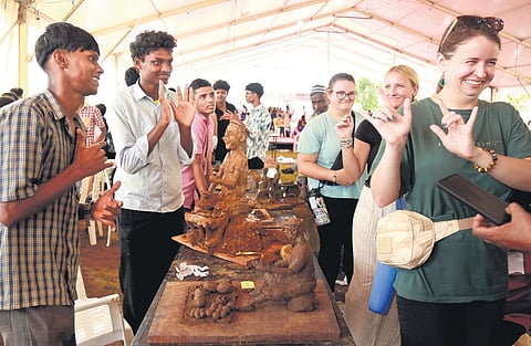 American tourists with special needs, who arrived in Alappuzha, interact in sign language with elated participants during the work experience category event