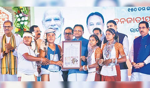 CM Mohan Majhi hands over habitat rights to PVTGs on the ocassion of Janjatiya Gaurav Diwas at Janata Maidan in Bhubaneswar, on Friday.