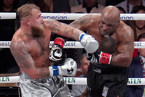 Jake Paul, left, fights Mike Tyson during their heavyweight boxing match, Friday, November 15, 2024.