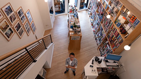 Yu Miao, owner of JF Books, poses for a photograph in his bookstore in Washington.