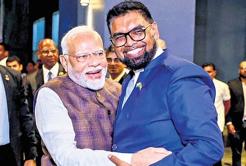 Prime Minister Narendra Modi being received by Guyana President Mohamed Irfaan Ali upon his arrival at Georgetown in Guyana on Wednesday.