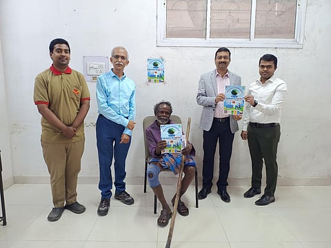 Periasamy Govindan with the poster which has QR code created for him. To  his right is Chief Postmaster General, Karnataka Circle, Rajendra S Kumar (blue) and to his right is LK Dash, Postmaster General, Bengaluru HQ Region.