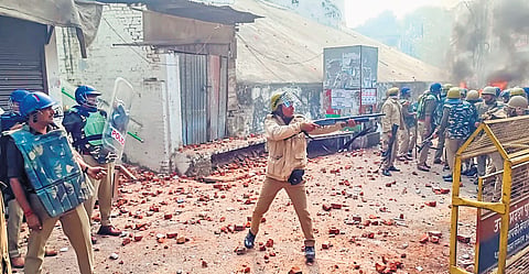Police try to control the situation amid violence during a second survey of the Jama Masjid, in Sambhal, Uttar Pradesh, on Sunday 