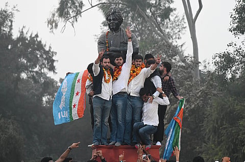 Newly elected DUSU President  Ronak Khatri and Joint Secretary Lokesh Chaudhari celebrate at statue of Swami Vivekanand, Delhi University. 